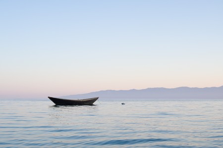a solitary pulling boat at a lake in the morningの写真素材