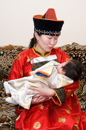 Mongolian woman rocks her baby to sleepの写真素材