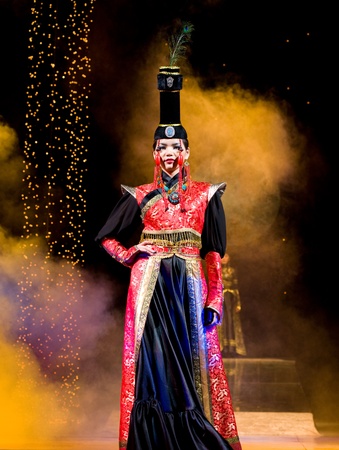 ULAN-UDE, RUSSIA - OCTOBER 29: An asian young woman demonstrates a gown in ethnic style at the international asian fashion festival on October, 29, 2009 in Ulan-Ude, Buryatia, Russia.のeditorial素材