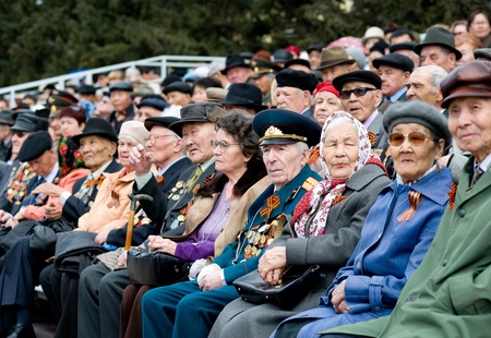 ULAN-UDE, RUSSIA - MAY 9: Elderly veterans of WWII sitting at tribunes watch the parade on annual...