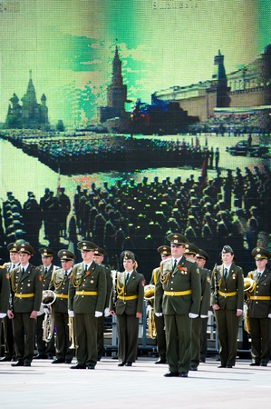 ULAN-UDE, RUSSIA - MAY 9: A marching band is in front of a TV panel broadcasting from Moscow, at the parade on annual Victory Day, May, 9, 2010 in Ulan-Ude, Buryatia, Russia.のeditorial素材