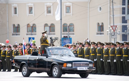 ULAN-UDE, RUSSIA - MAY 9: The commander standing in a car salute to officers - participants of the parade on annual Victory Day, May, 9, 2010 in Ulan-Ude, Buryatia, Russia.のeditorial素材