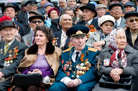 ULAN-UDE, RUSSIA - MAY 9: Elderly veterans of WWII sitting at tribunes watch the parade on annual Victory Day, May, 9, 2010 in Ulan-Ude, Russia.のeditorial素材