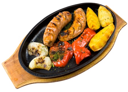 grilled sausages, potatoes and paprika, isolatedの写真素材