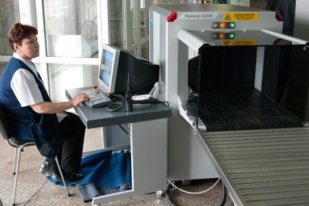 ULAN-UDE, RUSSIA - APRIL 2: The city airport opens international air routes and consequently a customs station on April 2, 2009, Ulan-Ude, Buryatia, Russia. Unidentified safety operator scans luggage.のeditorial素材