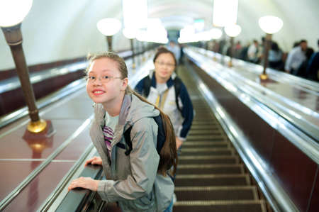 a girl (11 years) lifts on a metro escalatorの写真素材