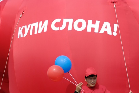 ULAN-UDE, RUSSIA - SEP 6  An unidentified employee of  Mobile telephone systems  goes in parade on City Day, Sep  6, 2008, Ulan-Ude, Buryatia, Russia  Red balloon has the sign  Buy an elephant のeditorial素材