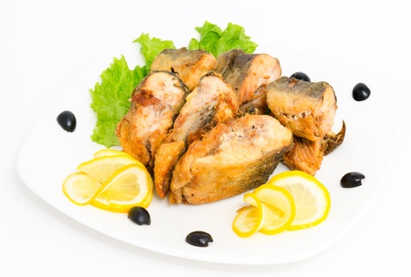 roasted salmon served with lettuce, lemon and olives