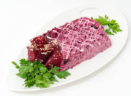 salad of salted herring under grated boiled vegetables and beetroot