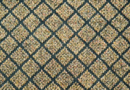 a dark gray carpet with a relief checked pattern