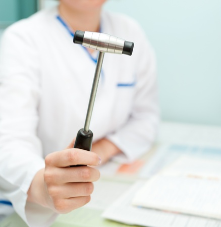 a doctor neuropathologist shows a reflex hammer to cameraの写真素材