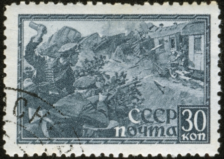 SOVIET UNION - CIRCA 1943  A stamp printed by the Soviet Union Post is entitled shows Russian soldiers attacking a fascist train, circa 1943のeditorial素材