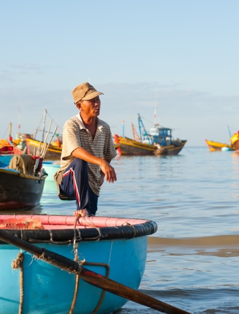 MUI NE, VIETNAM - FEBR 27  Mui Ne is a popular tourist attraction in Vietnam  An unidentified local fisher rests at his boat after the night fishing, February 27, 2013, Mui Ne, Phan Thiet, Vietnam のeditorial素材