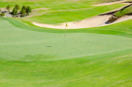 green grassy golf field on sunny dayの写真素材