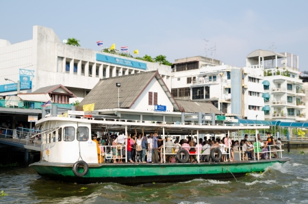 BANGKOK - FEB 17  A regular boat takes passengers at Ratchawong Pier at Chao Phraya river, Feb 17, 2013, Bangkok, Thailand  River transportation is more popular and faster than metro at Bangkok のeditorial素材