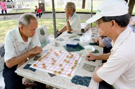 BANGKOK, THAILAND - FEBRUARY 17: Unidentified local senior men spend spare time playing Chinese chess in the street, February 17, 2013, Bangkok, Thailand. のeditorial素材