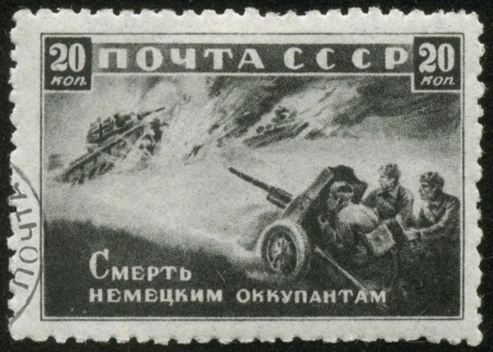 SOVIET UNION - CIRCA 1942  A stamp printed by the Soviet Union Post is entitled Death to German Invaders , circa 1942  It shows Russian artillerymen shooting at fascist tanks のeditorial素材