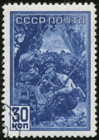 SOVIET UNION - CIRCA 1942  A stamp printed by the Soviet Union Post shows two Russian soldiers signallers, circa 1942 のeditorial素材