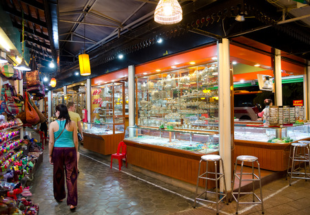 SIEM REAP, CAMBODIA - FEB 21, 2013: Unidentified tourists walk at the night market of Siem Reap. It serves as a gateway to the world famous Angkor temples and is a major tourist hub.のeditorial素材