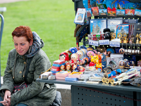 ST  PETERSBURG - MAY 29, 2011  An unidentified woman sells souvenirs, mainly Russian dolls, at street stand near St  Isaacs Cathedral  The city was the 10th most popular European tourist city in 2012 のeditorial素材