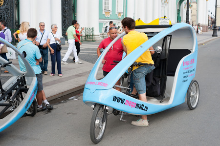 ST  PETERSBURG - JUNE 30, 2011  Unidentified drivers of cycle taxis wait at the Hermitage gateway for clients  Over 3 million people visit the museum every year のeditorial素材