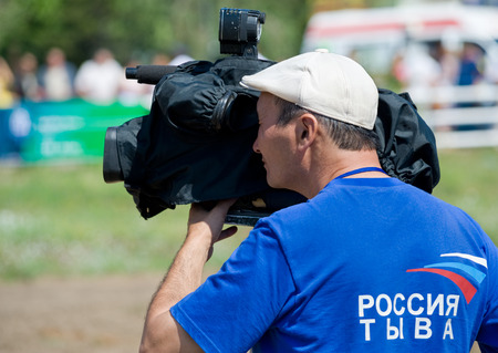 ULAN-UDE, RUSSIA - JULY 17, 2010  An unidentified television cameraman of Tuva State Television and Radio Company works at the opening of the 4th General Session of the World Mongolians Convention のeditorial素材