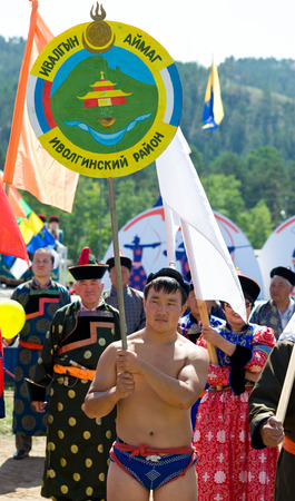 ULAN-UDE, RUSSIA - JULY 17, 2010  An unidentified wrestler holds the presentation plate of Ivolginsky district  of Buryatia  at the opening of the 4th General Session of World Mongolians Convention のeditorial素材