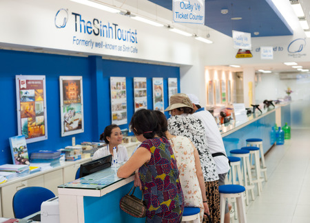 HO CHI MINH, VIETNAM - JULY 15, 2014: Unidentified people stand at the counter of the Sinh Tourist. According to many reviews the company seems to be Vietnam's most popular and reputable tour agency.のeditorial素材
