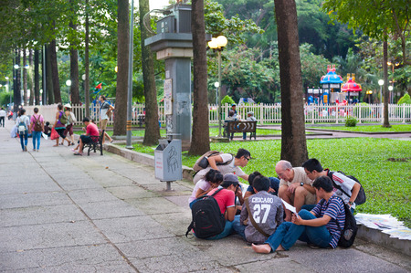 HO CHI MINH, VIETNAM - AUGUST 9, 2014: An unidentified Caucasian man teaches English to unidentified Vietnamese students in the park in Pham Ngu Lao Street.のeditorial素材