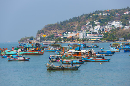 VUNGTAU, VIETNAM - JANUARY 15, 2015: Several ships and boats are at an anchor and move at the city port. The city is popular among Saigon people as sea resort.のeditorial素材