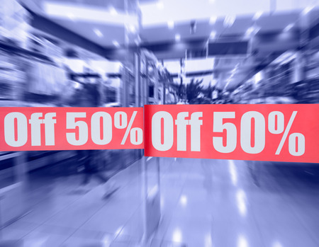 sign at shop entrance door - off 50% (violet blue toning)