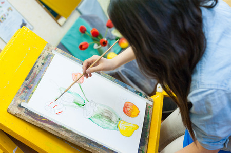 ULAN-UDE, RUSSIA - MAY 10, 2011: An unidentified girl paints at a drawing school of the City Palace of Childrens and Junior Arts, the biggest centre offering hobby circles and studies for children.のeditorial素材