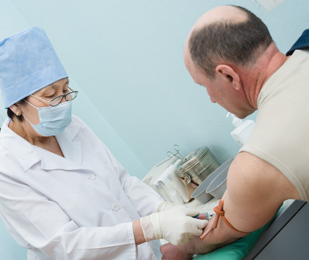 ULAN-UDE, RUSSIA - APRIL 6, 2010: An unidentified nurse makes blood test for volunteers before they donate blood. The City Blood Service makes a promo action for donorship popularization.のeditorial素材