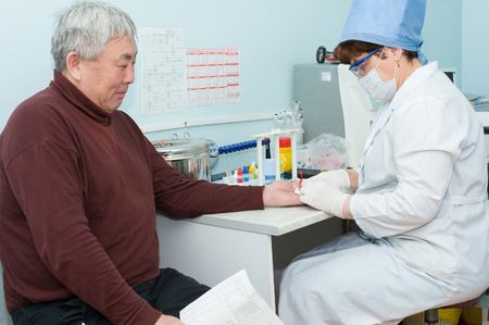 ULAN-UDE, RUSSIA - APRIL 6, 2010: An unidentified nurse makes blood test for volunteers before they donate blood. The City Blood Service makes a promo action for donorship popularization.のeditorial素材