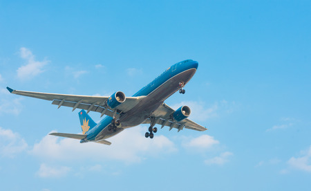 HO CHI MINH, VIETNAM - FEB 9, 2015: An unidentified plane of the Vietnam airlines approaches the Tan Son Nhat Airport. Vietnam Airlines is the flag carrier of Vietnam.のeditorial素材