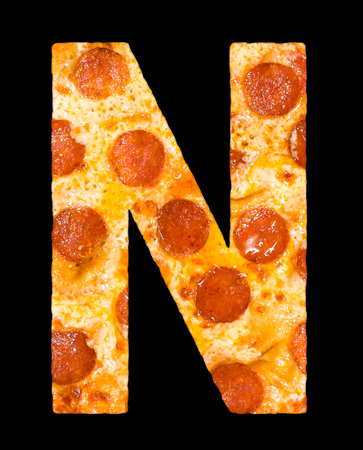 letter N cut out of pizza with peperoni and cheese, isolatedの写真素材
