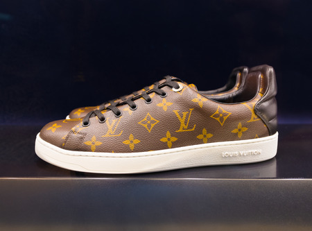 KUALA LUMPUR - JUNE 15, 2016: Louis Vuitton trainers in a showcase at the Suria KLCC shopping mall. For years 2006â2012 LV was named the worlds most valuable luxury brand.のeditorial素材