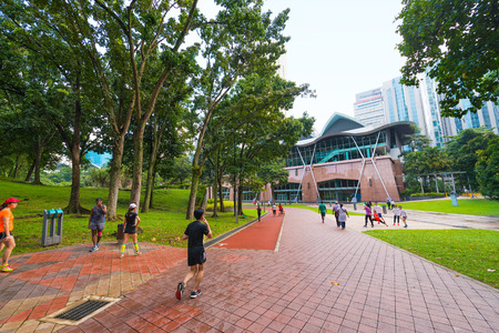 KUALA LUMPUR - JUNE 14, 2016: Townspeople do their sports at the KL City Centre Park Petronas Towers in the city center. Kuala Lumpur is the national capital and most populous global city in Malaysia.のeditorial素材
