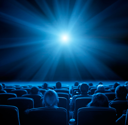 viewers watch film at movie theatre, long exposure, blue glowの写真素材