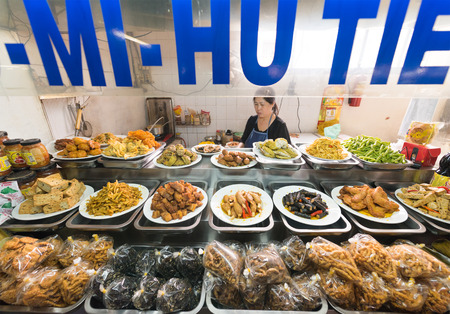 DA LAT, VIETNAM - AUGUST 6, 2016: A Vietnamese woman cooks and sells vegetarian food at the central city market.のeditorial素材