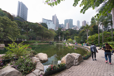 HONG KONG - MARCH 17, 2017: People walk in Hong Kong park. It is a public park, covering an area of 80,000 m2 and is an example of modern design and facilities blending with natural landscape.のeditorial素材