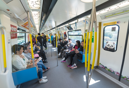 HONG KONG - MARCH 16, 2017: People sit in a metro carriage. The Mass Transit Railway is one of the most profitable metro systems in the world, with a high farebox recovery ratio of 124% in 2016.のeditorial素材