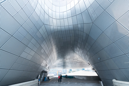 SEOUL - MARCH 25, 2017: People walk by the Dongdaemun Design Plaza (DDP), the centerpiece of South Korea's fashion hub and popular tourist destination.のeditorial素材