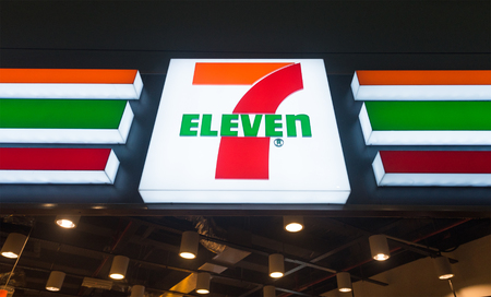 KUALA LUMPUR - JUNE 17, 2017: The signboard of 7 Eleven store at KLIA 2 airport. 7 Eleven (7 11) is an international chain of convenience stores that operates some 58300 stores in 17 countriesのeditorial素材