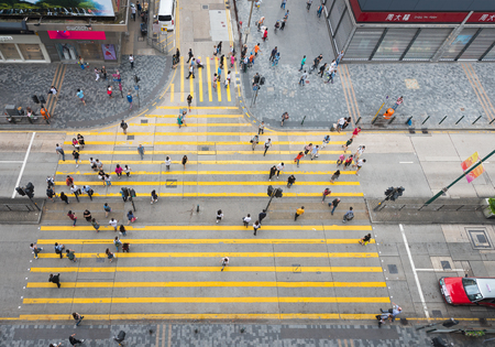 HONG KONG - SEPT 15, 2017: People walk on the pedestrian crossing between Peking Road and Nathan Road. It is a high angle view from Chungking Mansions famous with its budget accommodation.のeditorial素材