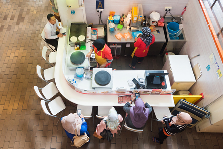 KUALA LUMPUR - SEPT 2017: Unidentified people eat stuffed pancakes at Hot and Roll kiosk at Central Market. It was founded in 1888 and originally used as a wet marketのeditorial素材