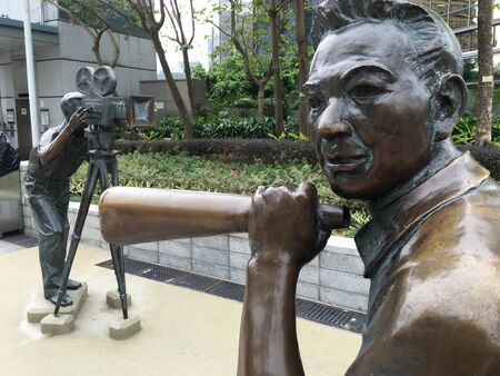 HONG KONG - MARCH 2017: Statues of cameraman and director are temporarily located in the Garden of Stars from Avenue of Stars which is closed off for three years for its redevelopment and expansion.のeditorial素材