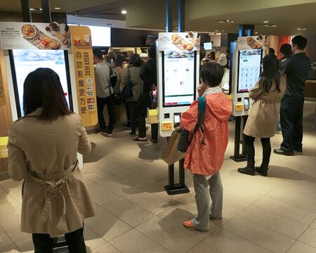 HONG KONG - MARCH, 2017: People order food at self service kiosks at a McDonalds in Peking Road....