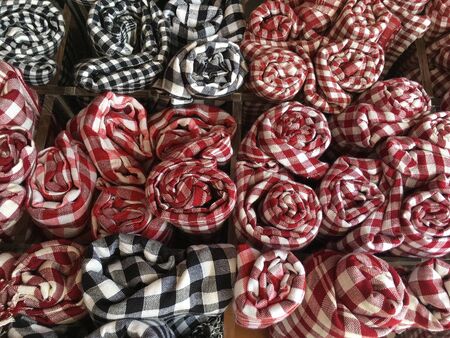 many keffiyehs, checkered cotton scarves, at night market in Siem Reap, Cambodia