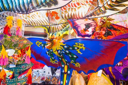 colorful kites shaped as birds and dragons for saleのeditorial素材